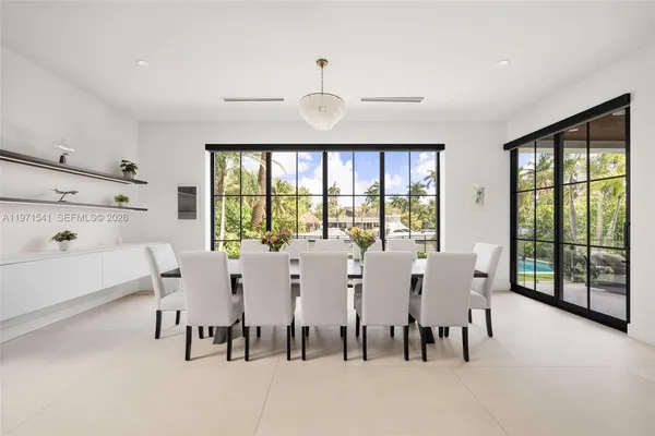a living room with furniture and a floor to ceiling window