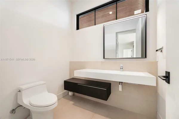 a spacious bedroom with a large bed and a window