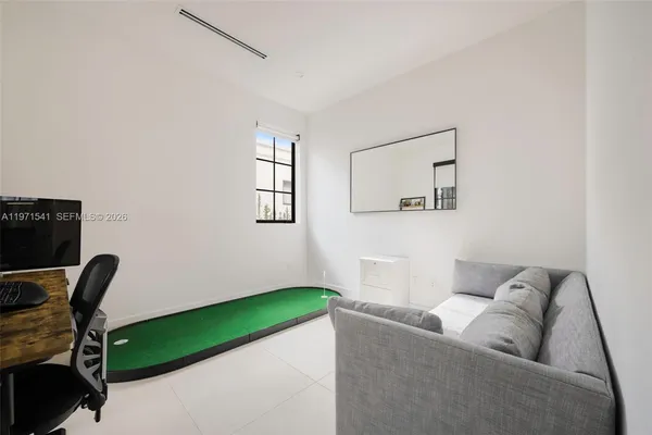 a view of a hallway with wooden floor and windows