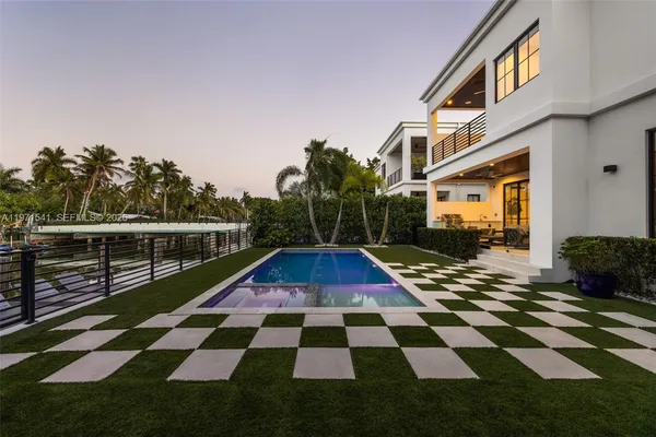 a view of yard with swimming pool and furniture
