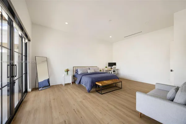 a spacious bedroom with a bed and large window