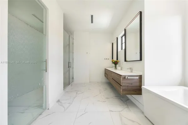 a bedroom with a large bed and a tv