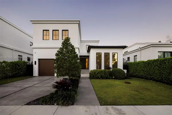 a front view of a house with a garden