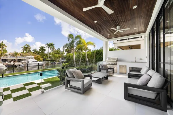 a view of a house with swimming pool and sitting area