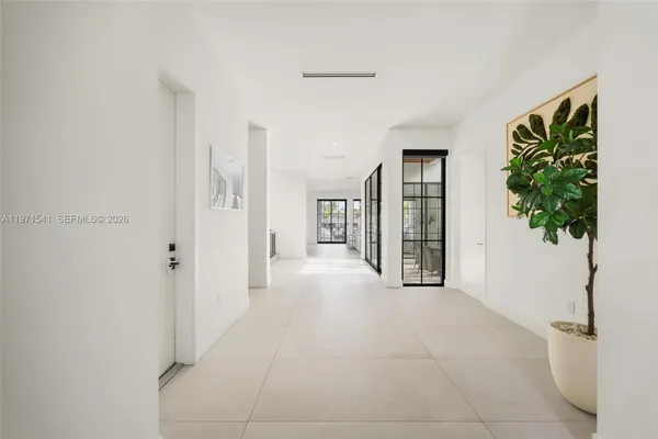 a view of a hallway with entryway door and living room