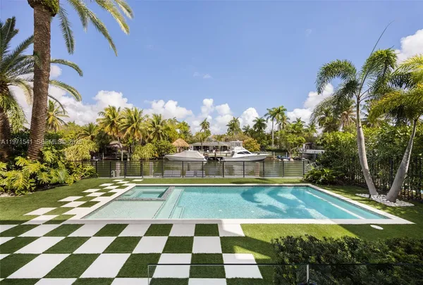 a view of a house with swimming pool and sitting area