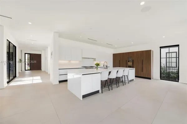 a kitchen with kitchen island a sink a stove and a refrigerator