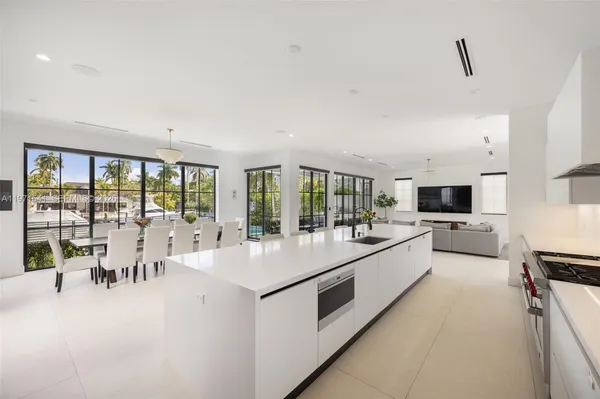 a view of a dining room with furniture and chandelier