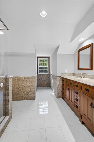 a bathroom with a sink a mirror and bathtub