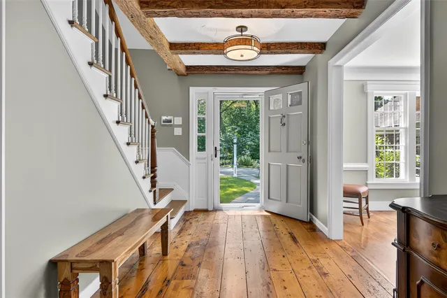 a view of an entryway with wooden floor