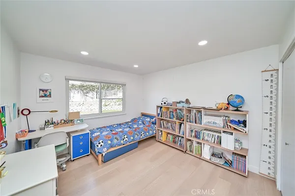 a bedroom with furniture and a window