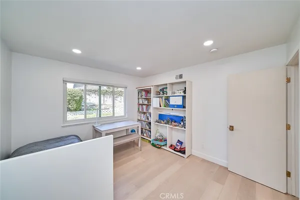 a living room with furniture and a bookshelf