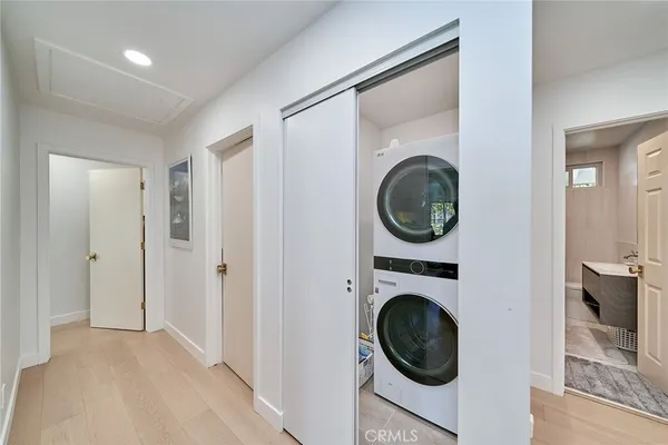 a view of a hallway with washer and dryer