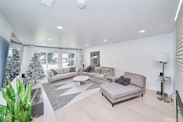 a living room with furniture potted plant and a window