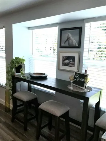 a kitchen with a table chairs a sink and a window