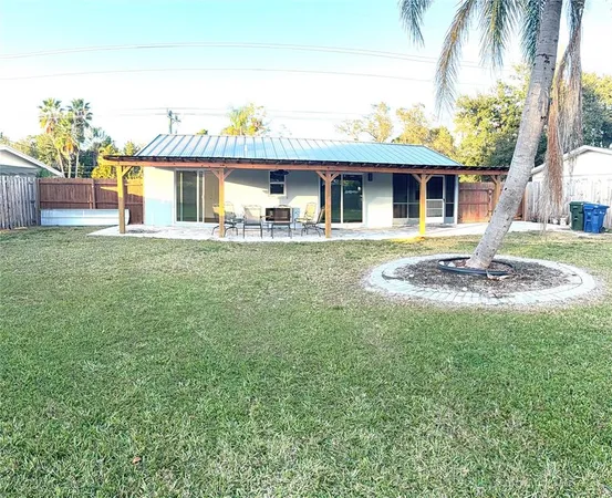 a view of a house with pool and a yard