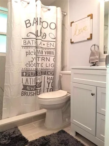 a bathroom with a toilet and a shower