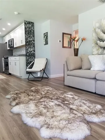 a living room with furniture and a rug