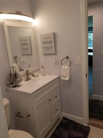 a bathroom with a sink toilet and mirror
