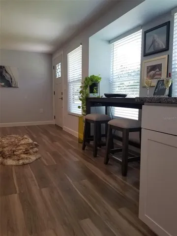 a workspace with furniture window and wooden floor