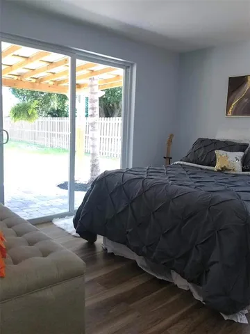 a bedroom with a bed and glass window