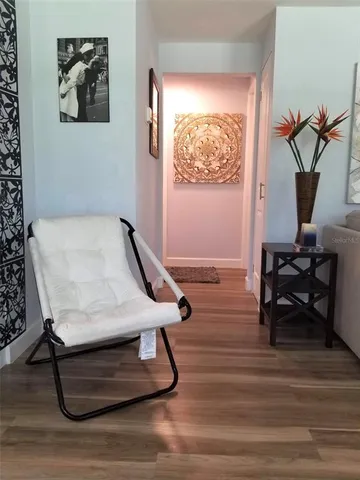 a room with gym equipment and wooden floor