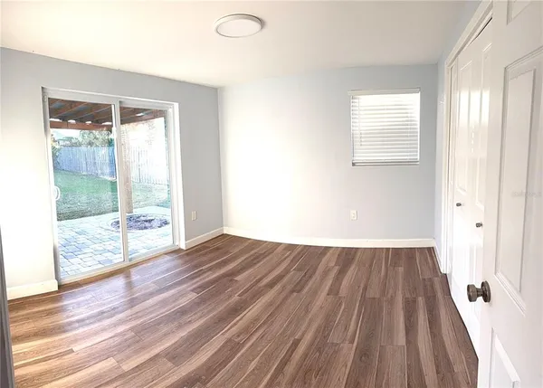 a view of wooden floor and windows in a room