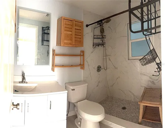 a bathroom with a sink toilet and shower