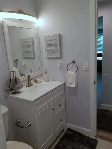 a bathroom with a sink vanity and mirror