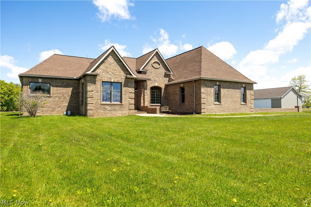 51488 Peck Wadsworth Road Wellington, OH 44090 - Photo 6 of 50 Brick exterior residence featuring a prominent gabled entry