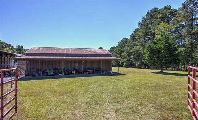 a view of a house with swimming pool and a yard