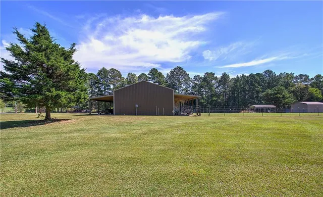 a big yard with trees in the background