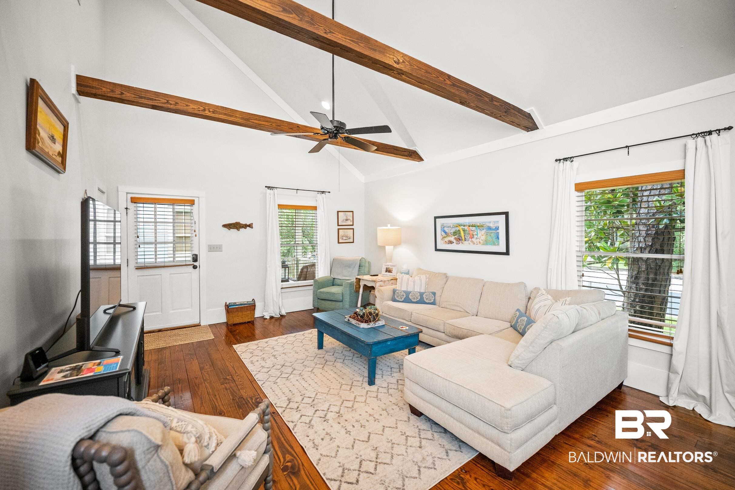 25773 Canal Road, Unit 18 Orange Beach, AL 36561 - Photo 5 of 44 Living room with high vaulted ceiling, hardwood / wood-style floors, ceiling fan, beamed ceiling, and healthy amount of natural light