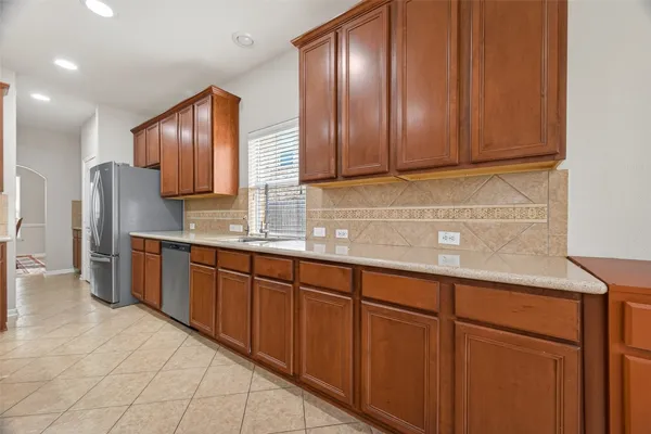 a kitchen with stainless steel appliances granite countertop a refrigerator and stove