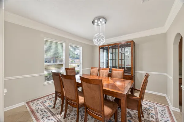 a view of a kitchen with white cabinets and entryway
