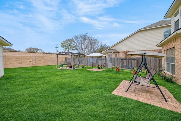 a view of a house with a backyard