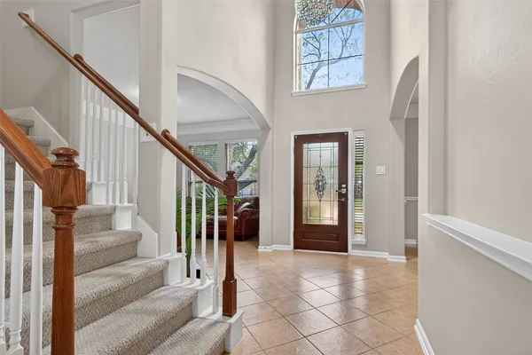a view of staircase with lots of frames and couches