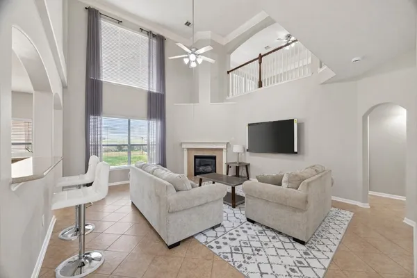 a living room with furniture a fireplace and a flat screen tv