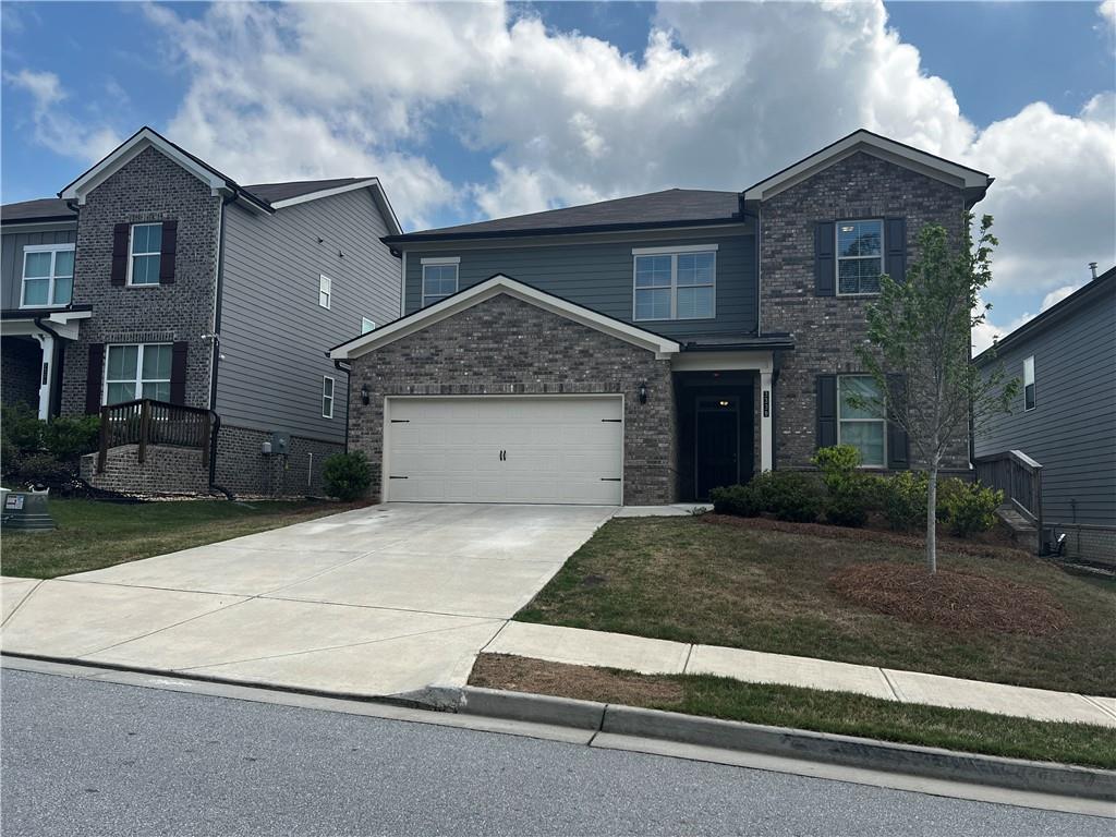 3339 Fall Branch Lane Buford, GA 30519 - Photo 2 of 30 a front view of a house with a yard and garage