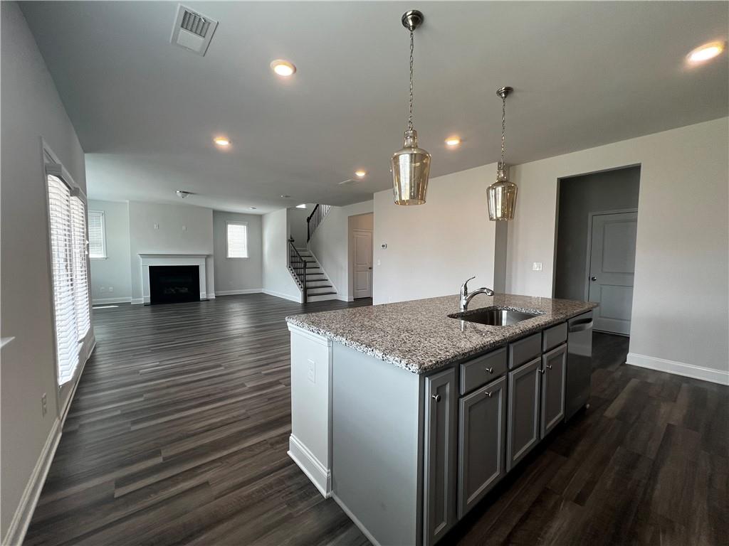 3339 Fall Branch Lane Buford, GA 30519 - Photo 3 of 30 a kitchen with stainless steel appliances granite countertop a kitchen island a stove and a wooden floors
