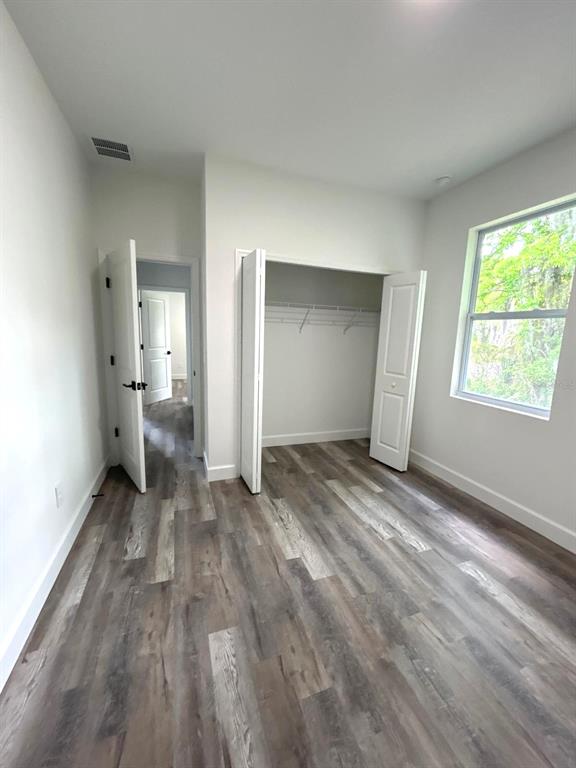 1683 Southwest 3rd Street Ocala, FL 34471 - Photo 14 of 14 a view of a room with wooden floor cabinet and a bathroom