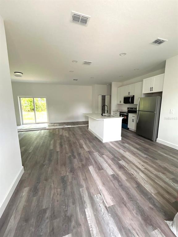 1683 Southwest 3rd Street Ocala, FL 34471 - Photo 6 of 14 an empty room with wooden floor and windows