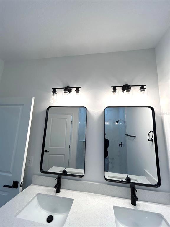1683 Southwest 3rd Street Ocala, FL 34471 - Photo 9 of 14 a bathroom with double vanity sinks and two mirror