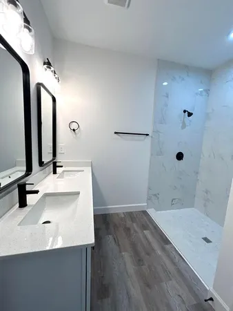 a bathroom with a tub sink and mirror