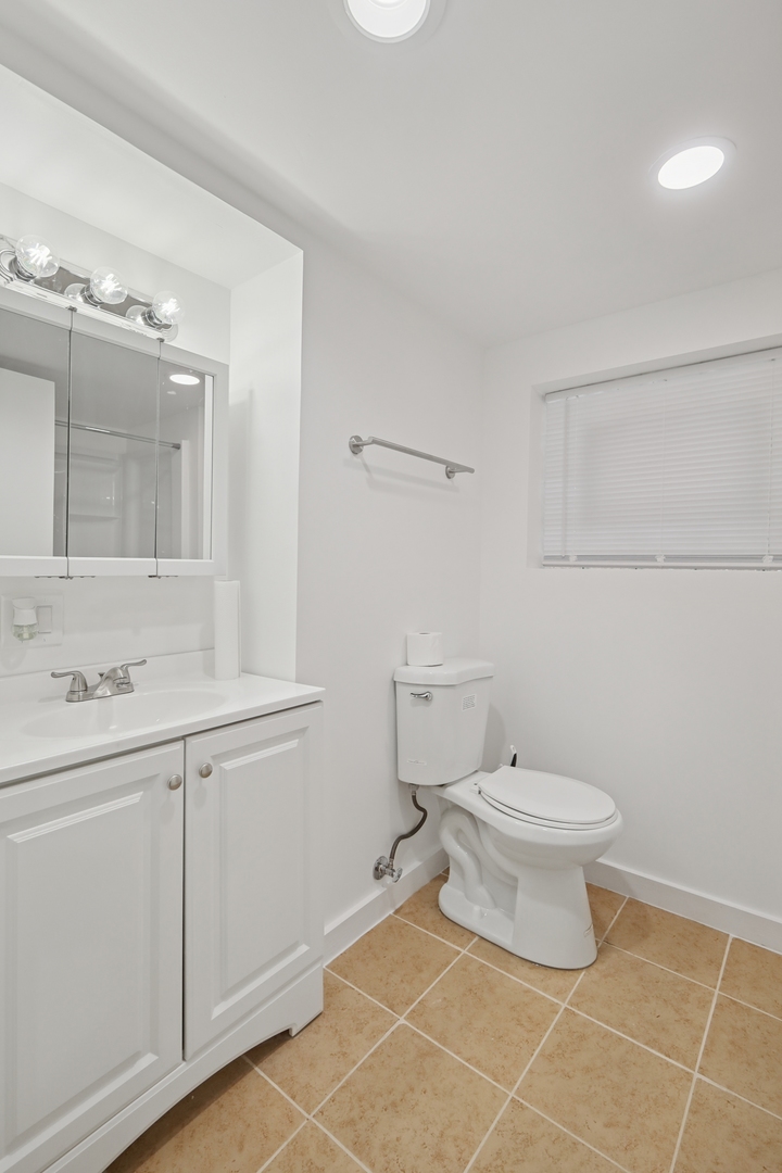 1711 West 43rd Street Chicago, IL 60609 - Photo 19 of 25 a bathroom with a toilet a sink and mirror