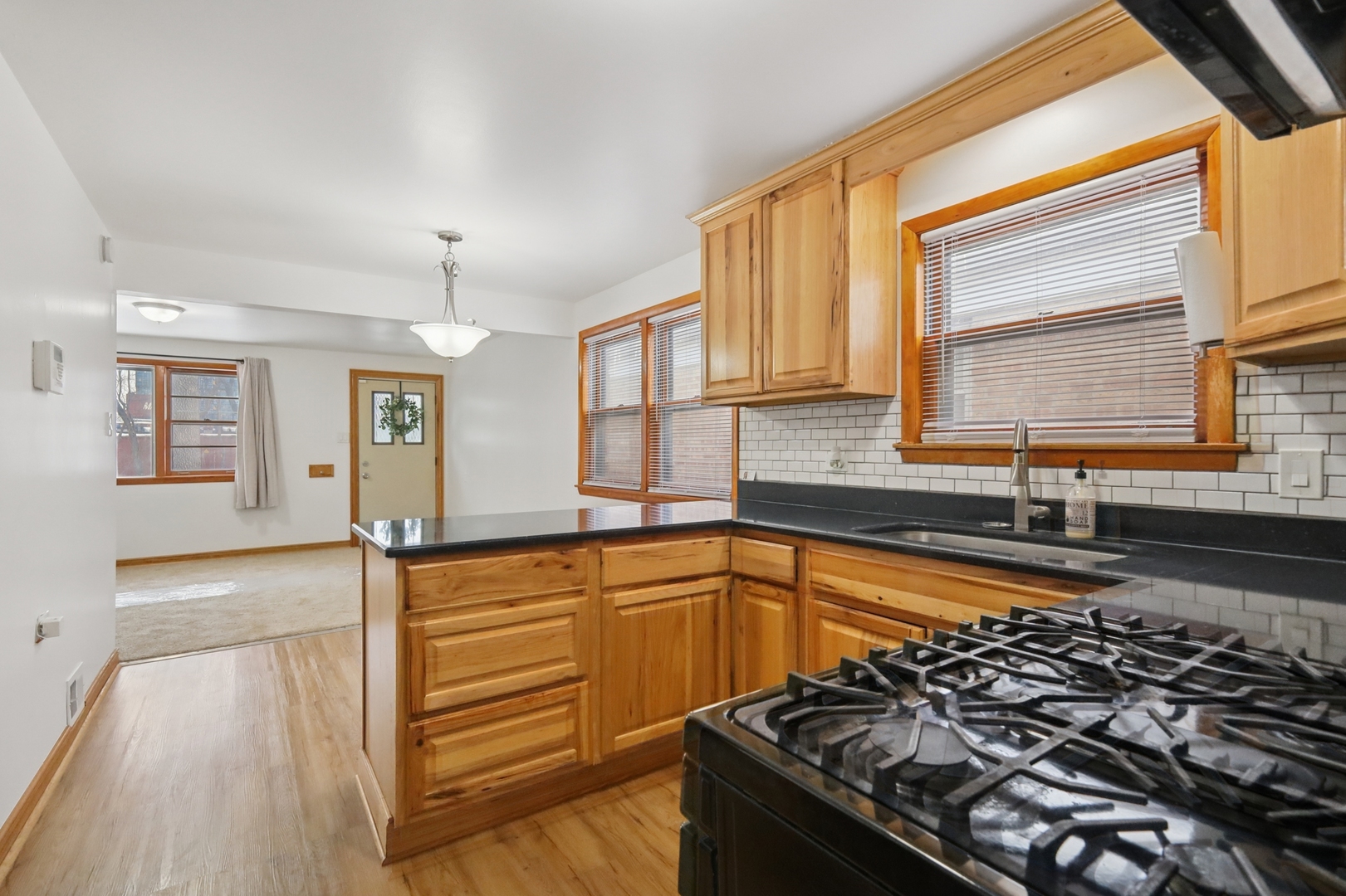 1711 West 43rd Street Chicago, IL 60609 - Photo 7 of 25 a kitchen with granite countertop a stove and a sink
