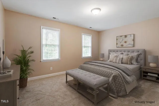 a spacious bedroom with a bed and a window
