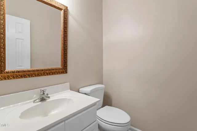 a bathroom with a sink a toilet and mirror