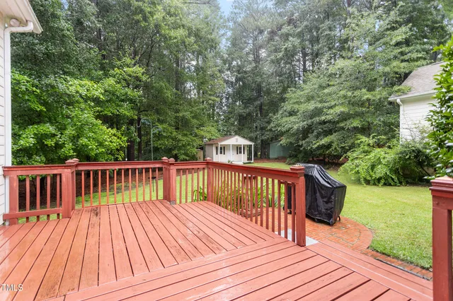 a view of balcony with wooden floor and fence