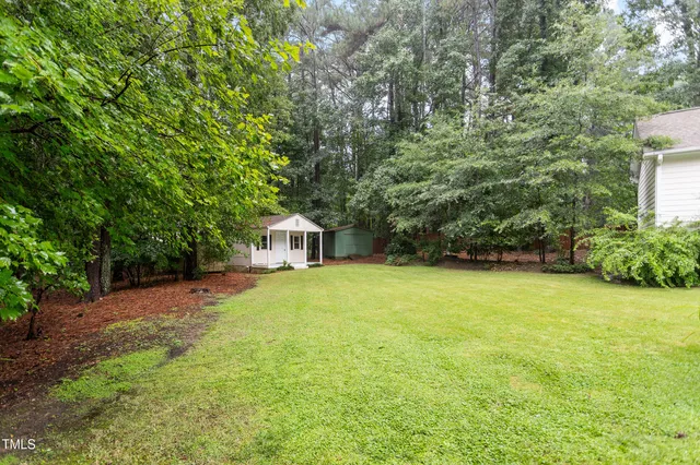 a yellow house with trees in front of it